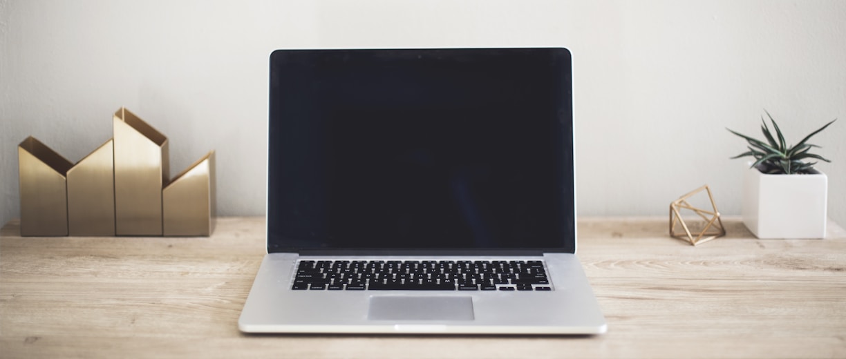 MacBook Pro on top of brown table