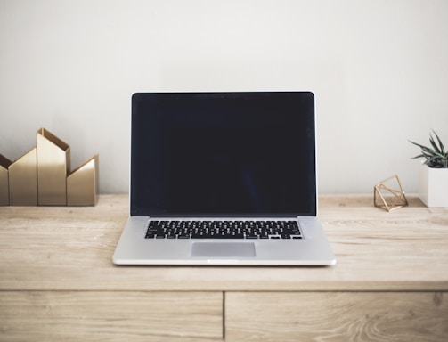 MacBook Pro on top of brown table