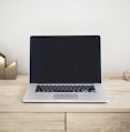 MacBook Pro on top of brown table