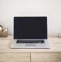 MacBook Pro on top of brown table