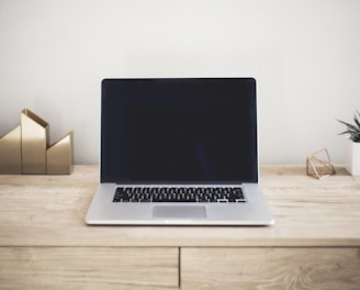 MacBook Pro on top of brown table