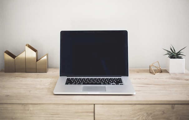 MacBook Pro on top of brown table