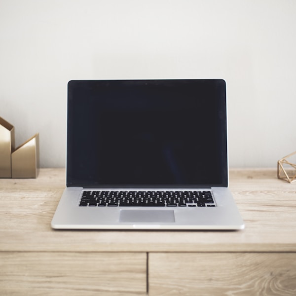 MacBook Pro on top of brown table