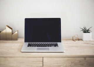 MacBook Pro on top of brown table