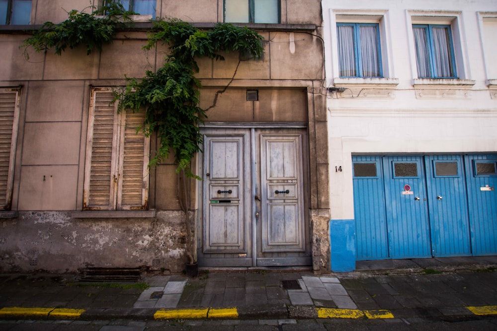 closed gray two-doors of brown concrete building