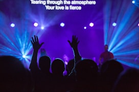 silhouette of people against purple background