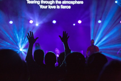 silhouette of people against purple background