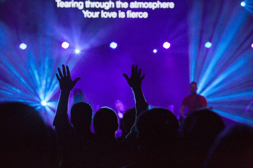 silhouette of people against purple background