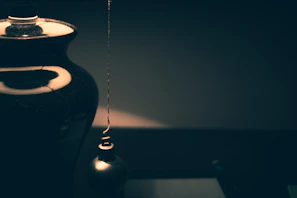 Close-up of a sleek, custom 3D printed geometric vase in matte black finish.