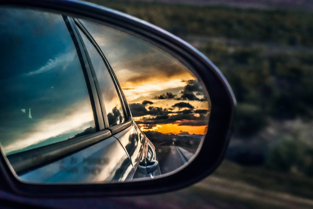 side mirror showing dark sky