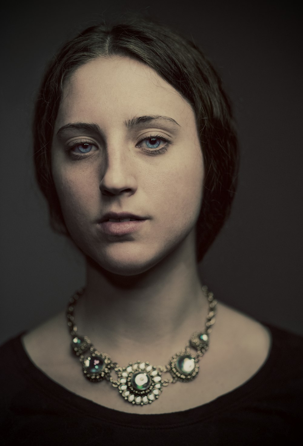 portrait photography of woman in black top