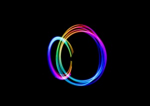 time-lapse photography of person doing circle rainbow light