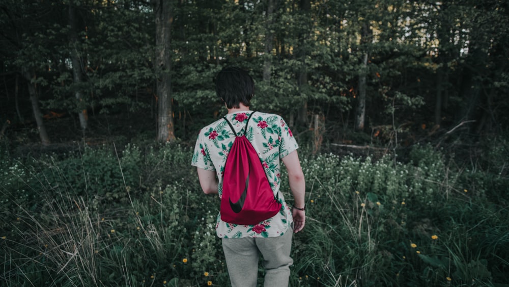 man walking along the forest