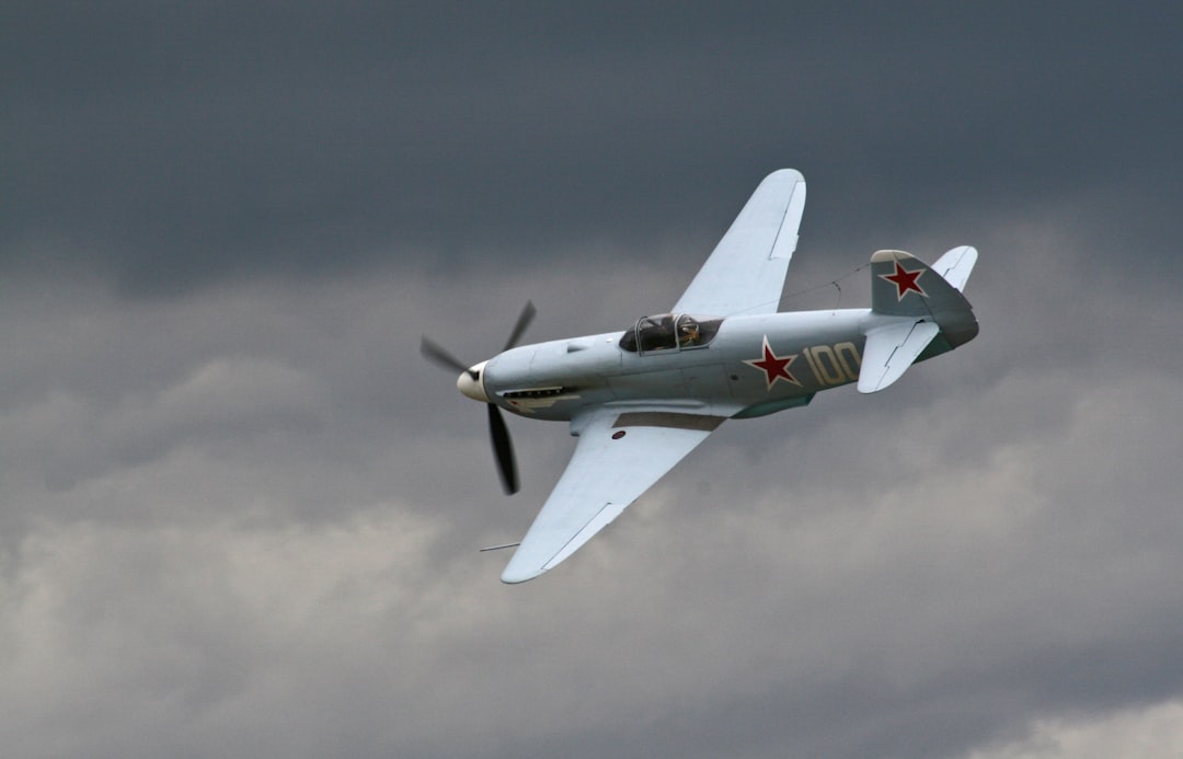 gray bi-plane under gray clouds, Russian fighter with clouds
