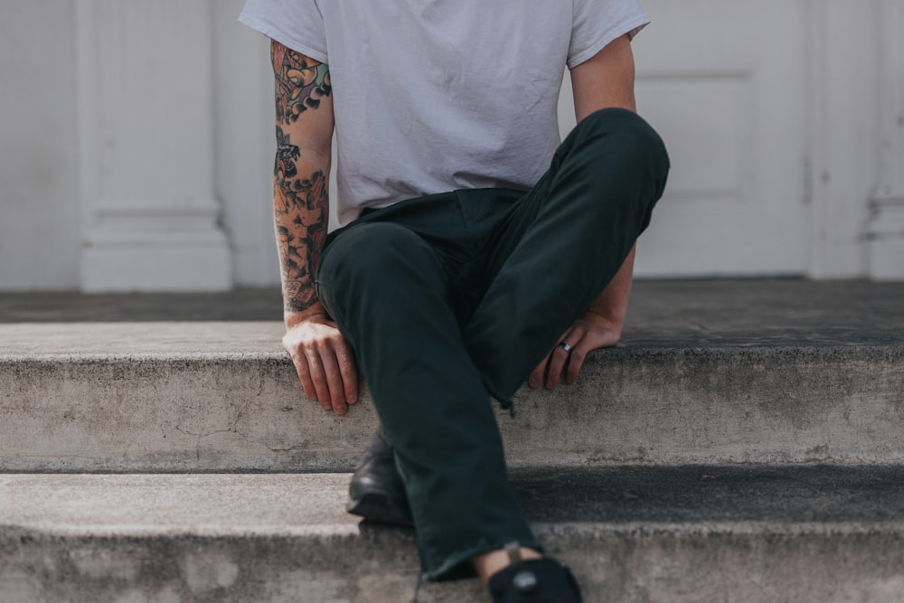 person sitting on gray concrete flooring