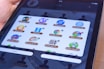 A teacher demonstrating an interactive educational app on a tablet to eager students.
