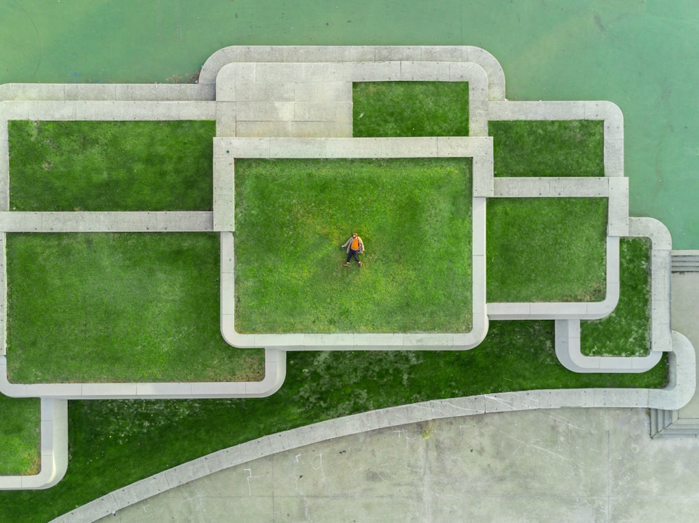 bird's eyeview photo of person lying on green grass