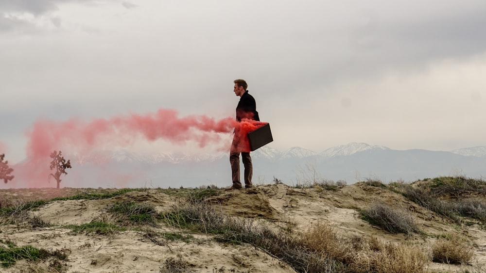 Red smoke coming out of a man's briefcase.