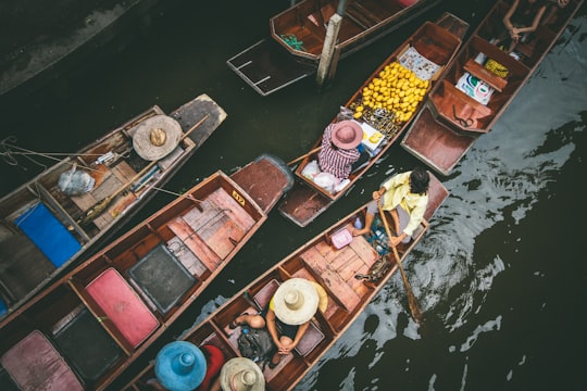 people rowing boat in Damnoen Saduak Floating Market Thailand