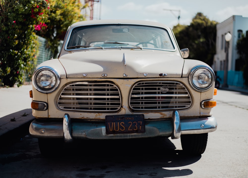 white Volvo car parked on roadside at daytime