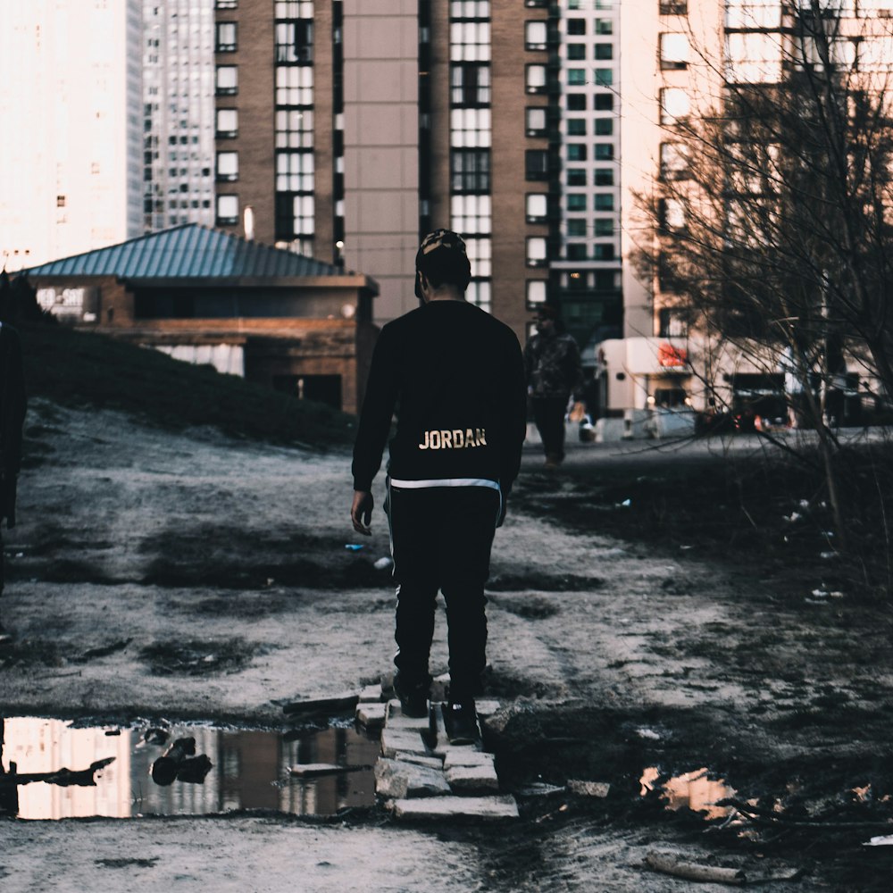 person standing on gray bricks