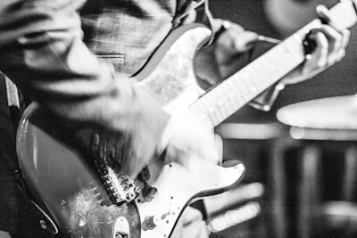 Black and white portrait of a musician mid-performance, capturing raw emotion.