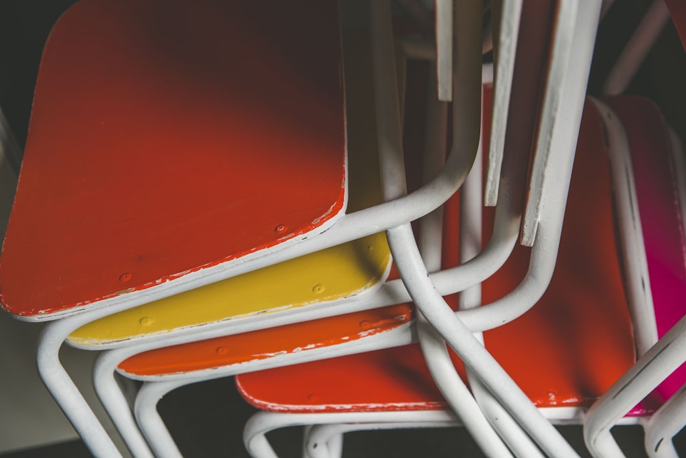 stacked of orange and yellow metal chairs