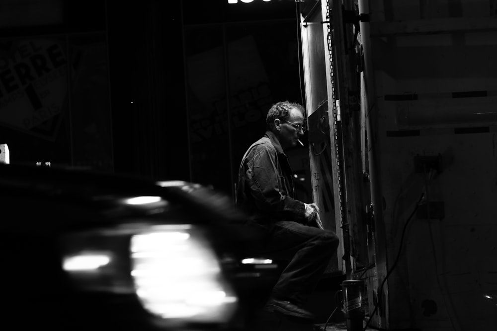 man sitting down near mirror