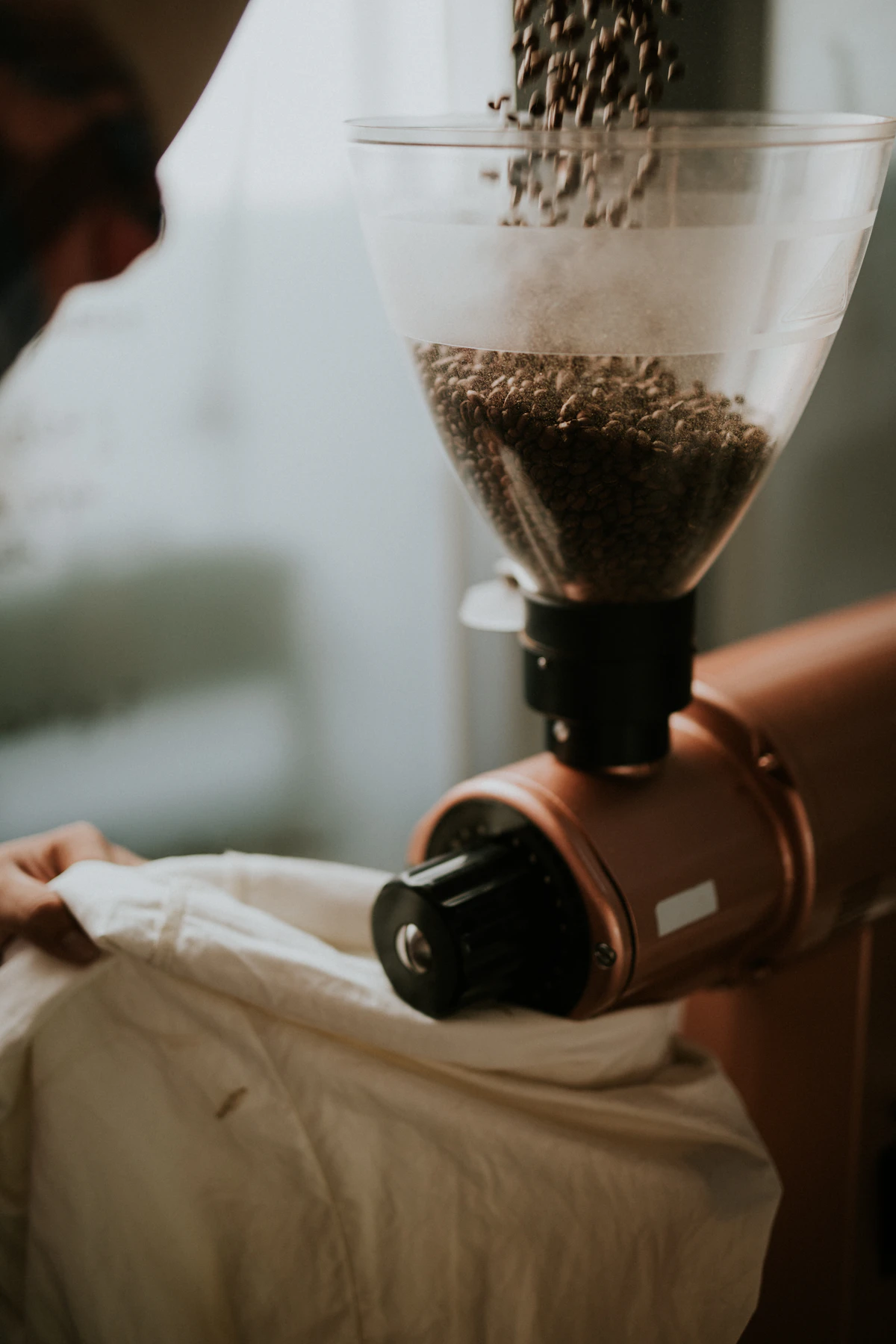 Coffee beans being ground in a grinder