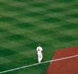 Action shot of baseball player wearing a clean, white baseball jersey