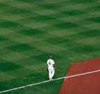 Action shot of baseball player wearing a clean, white baseball jersey