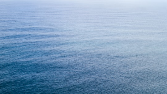 landscape photo of body of water in Cliffs of Moher Ireland