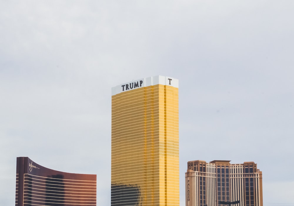 gold-colored Trump high-rise building between of two gold-colored buildings