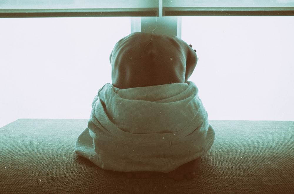 woman sitting on black surface inside room