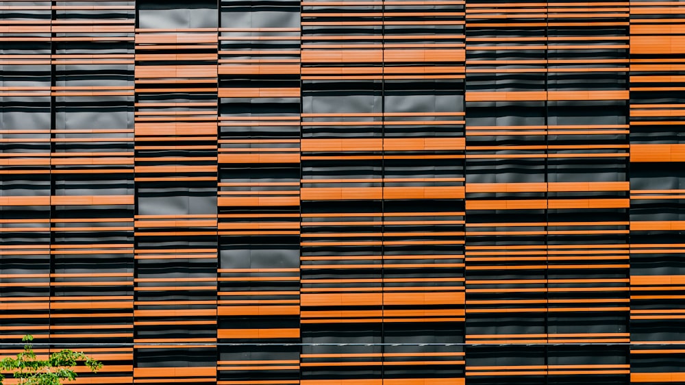 orange and black glass building at daytime