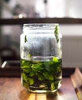 A refreshing mint syrup bottle with mint leaves.