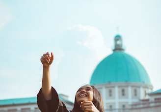 woman throwing her academic hat