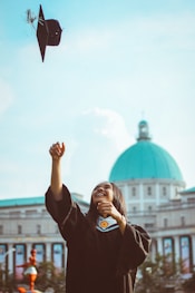woman throwing her academic hat