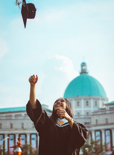 woman throwing her academic hat