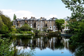 photo of brown houses near body of water