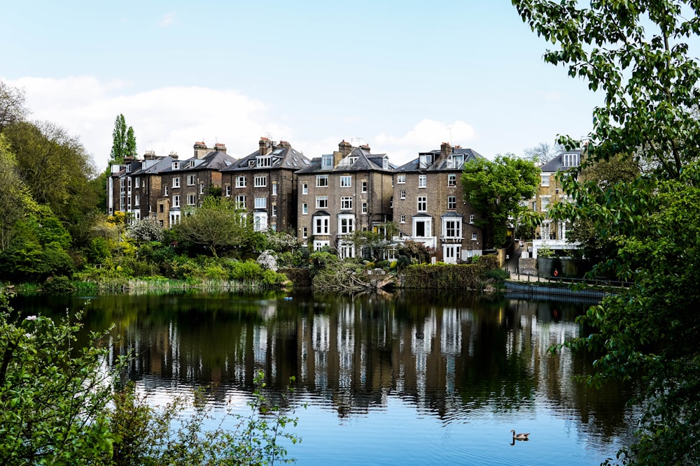 photo of brown houses near body of water