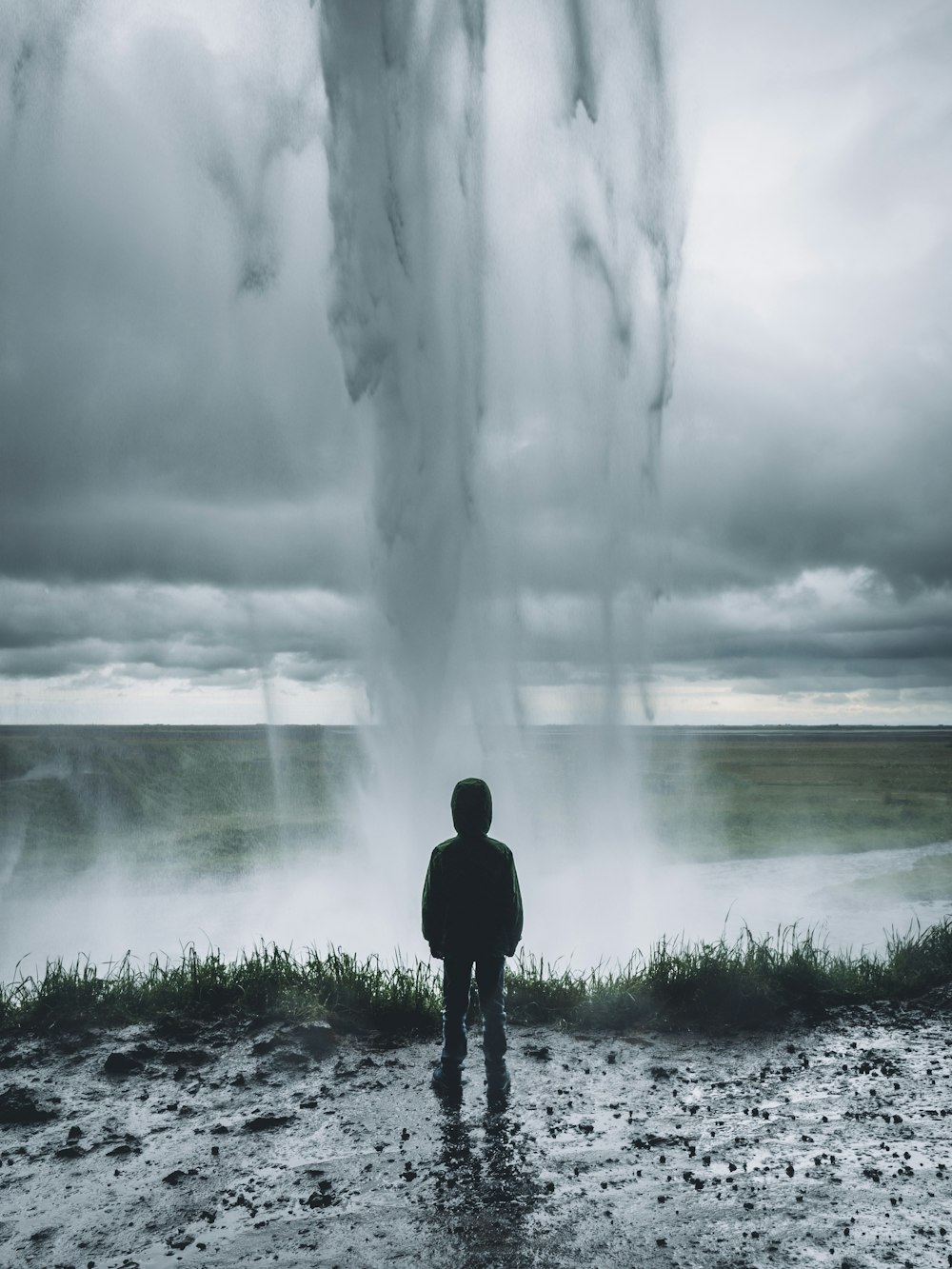 toddler standing in front of water formation