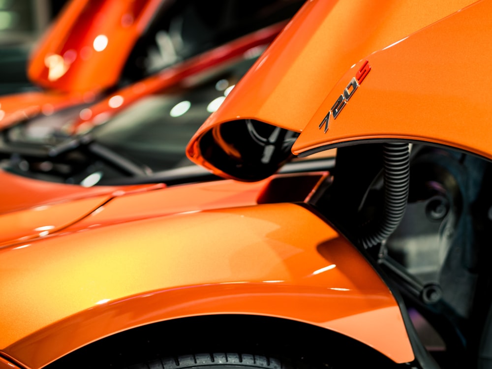 Suicide doors on an orange sports car.