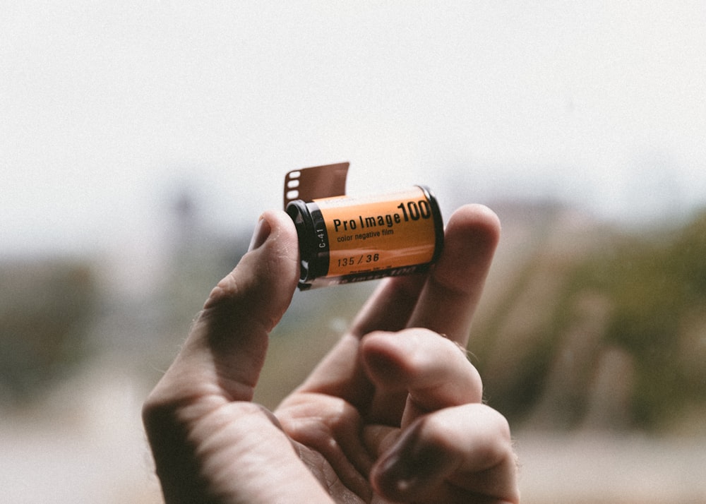 person holding Pro Image 100 tape