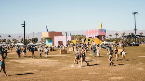 A candid shot of festival attendees engaging with interactive art installations outdoors.