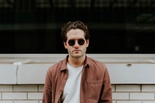man standing in front of white concrete wall
