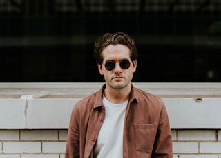 man standing in front of white concrete wall