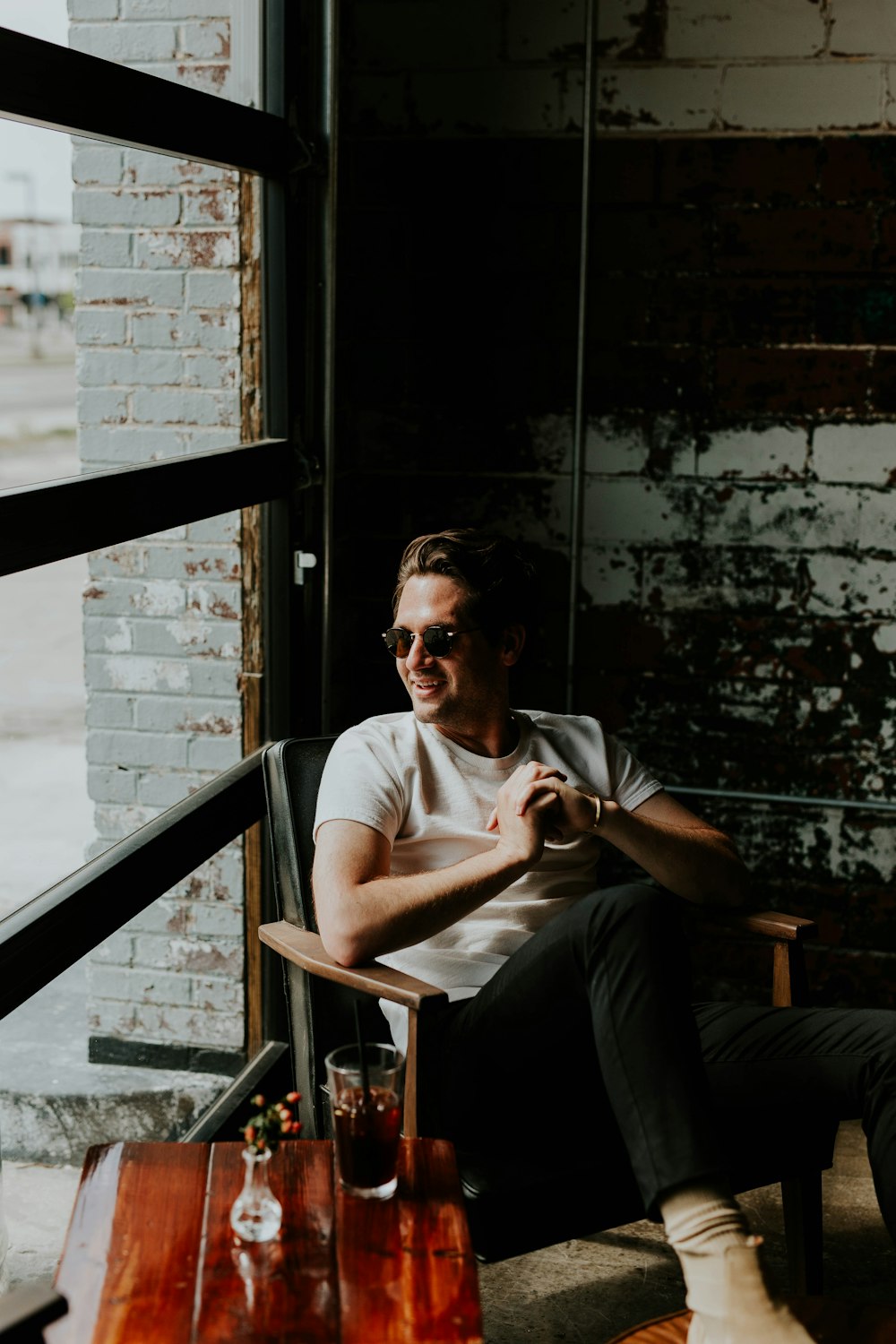 unknown person sitting on brown armchair indoors