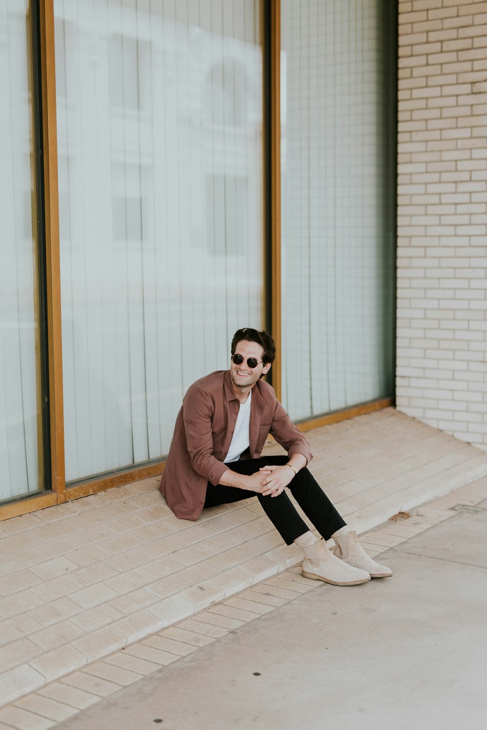 smiling man sitting in door front