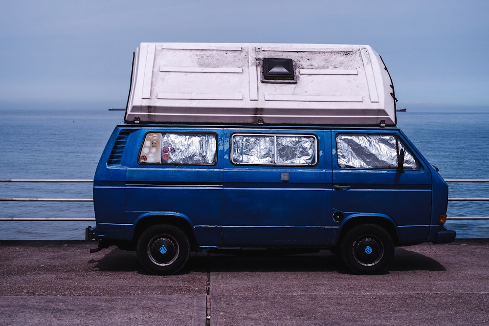 blue van with container on roof